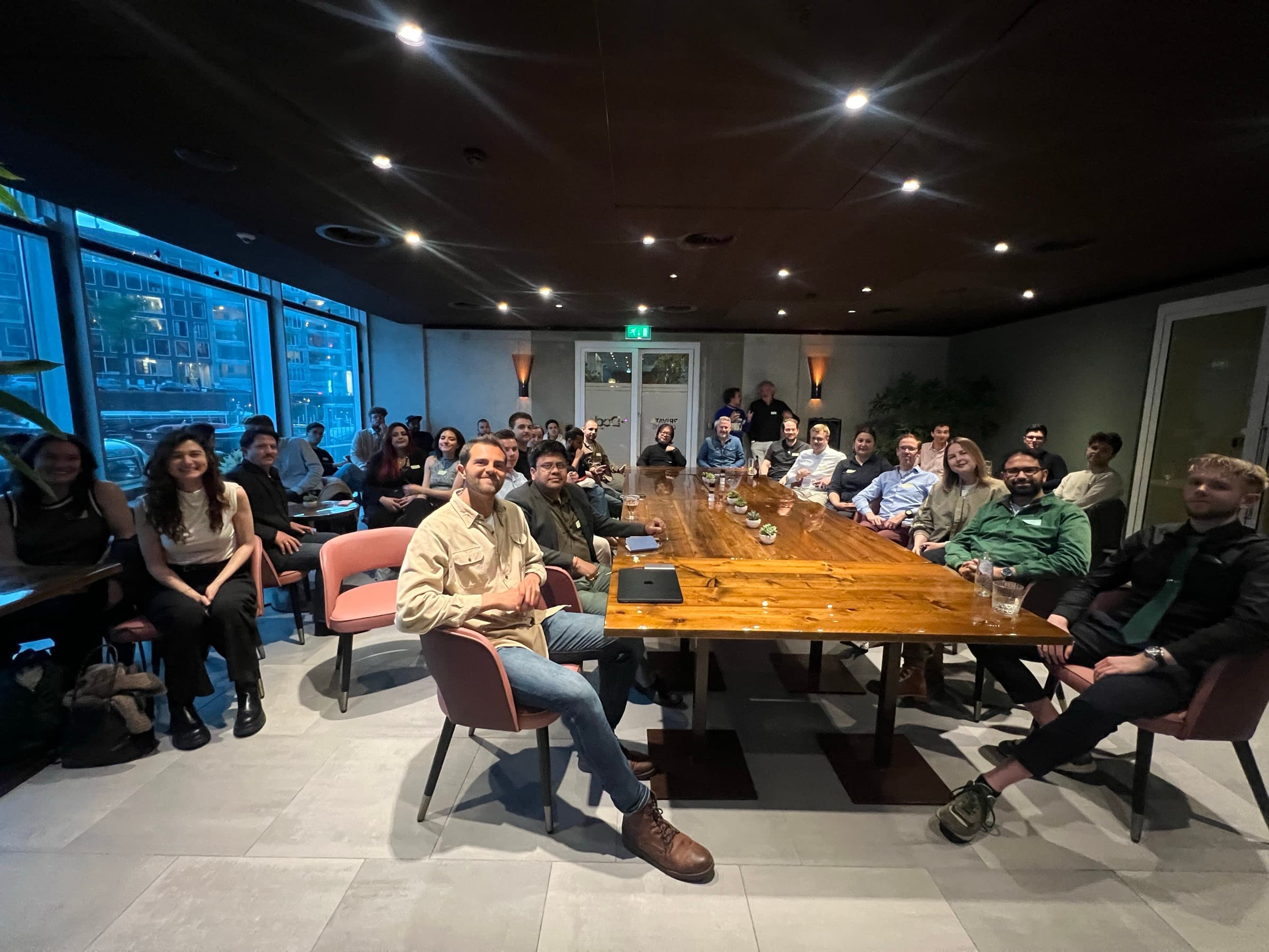 Community gathered at the long table at a Startup Valley night in Amsterdam