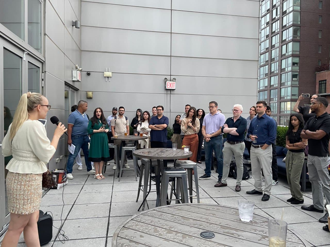 Host on the mic as doors open at a Startup Valley night in New York
